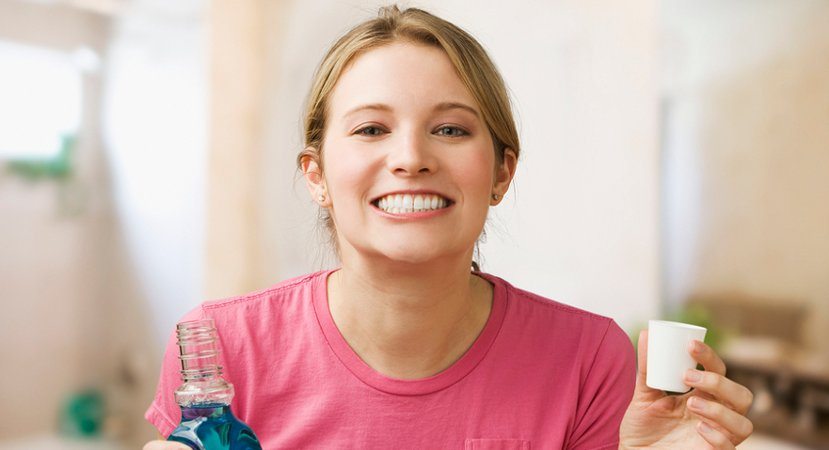 rinsing teeth with mouthwash